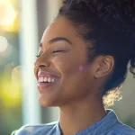 a smiling woman receiving an expert adjustment from an atlanta chiropractor, with bright, natural light streaming through the window.