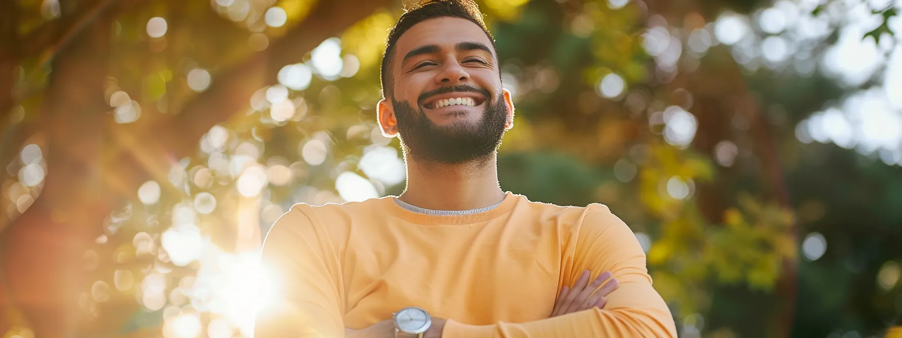 a smiling individual standing tall with a relieved expression, showcasing the transformative impact of chiropractic care on overcoming back pain.